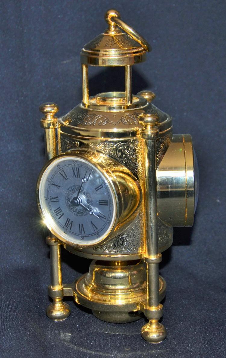  Decorative table clock with barometer and thermometer combination.