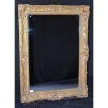 Eye catching Mirror in a richly ornamented and gilded wooden frame